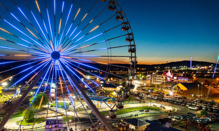 A neon-lit ferris wheel overlooks the bright lights of Branson.